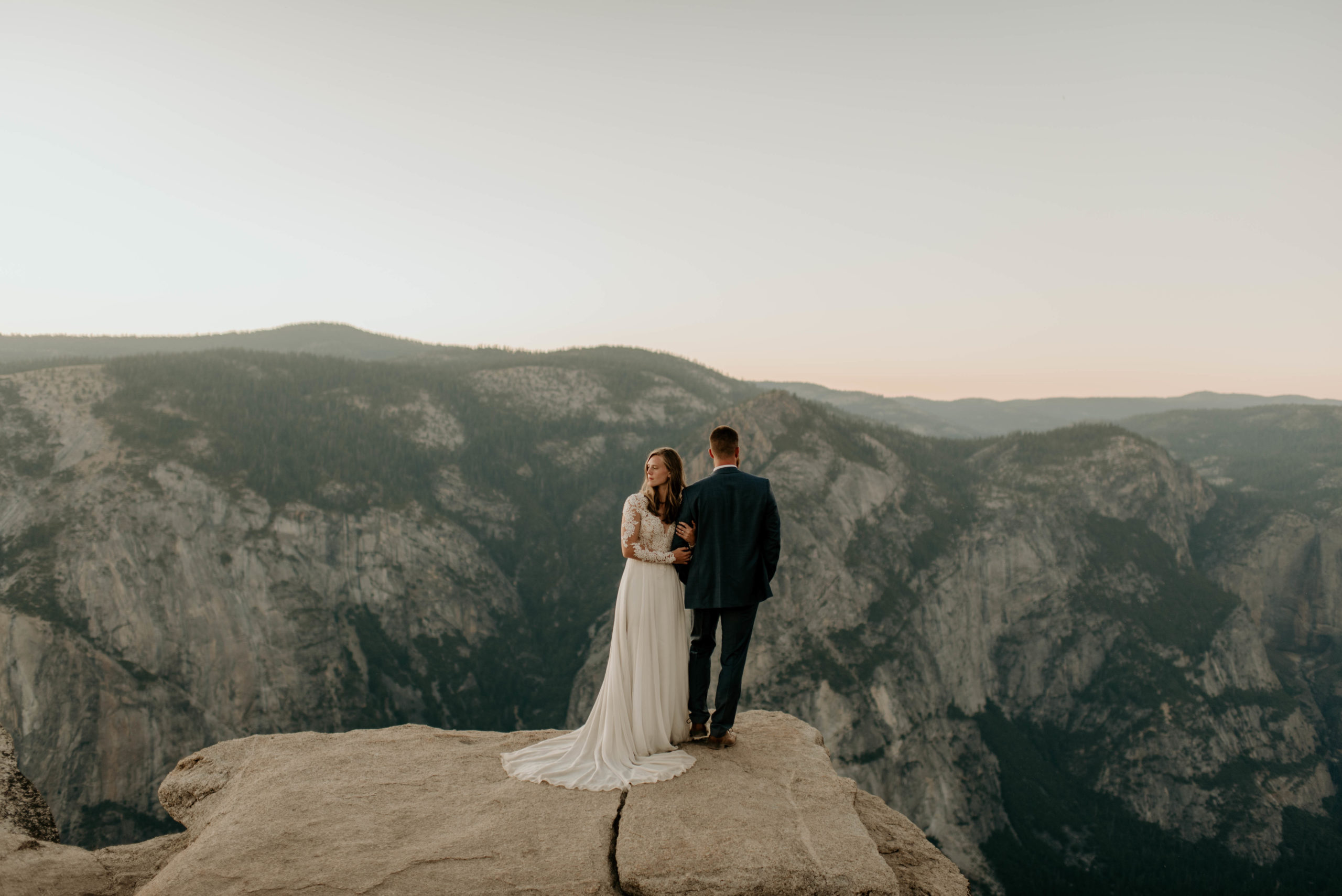 Couple stands at mountain overlook elopement