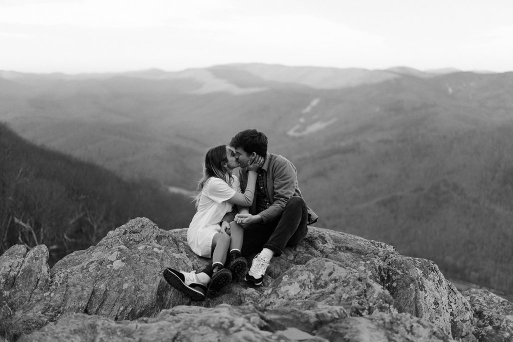 Couple kisses at surprise proposal overlook