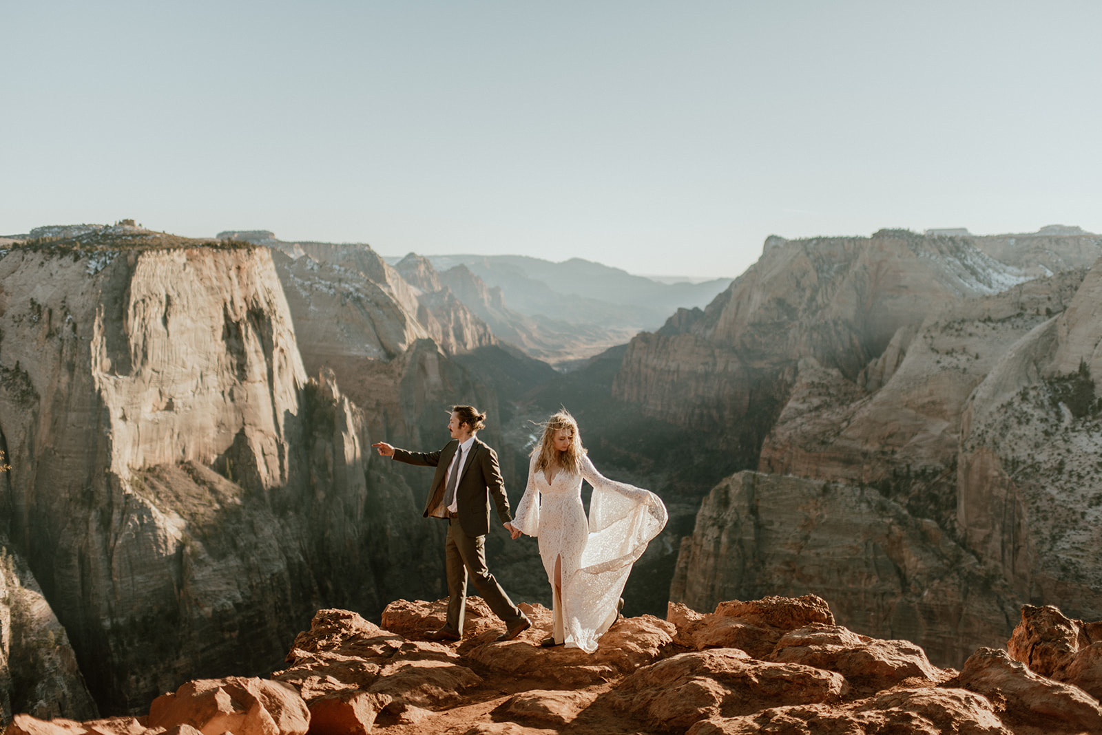 Couple holds hands at Zion overlook elopement