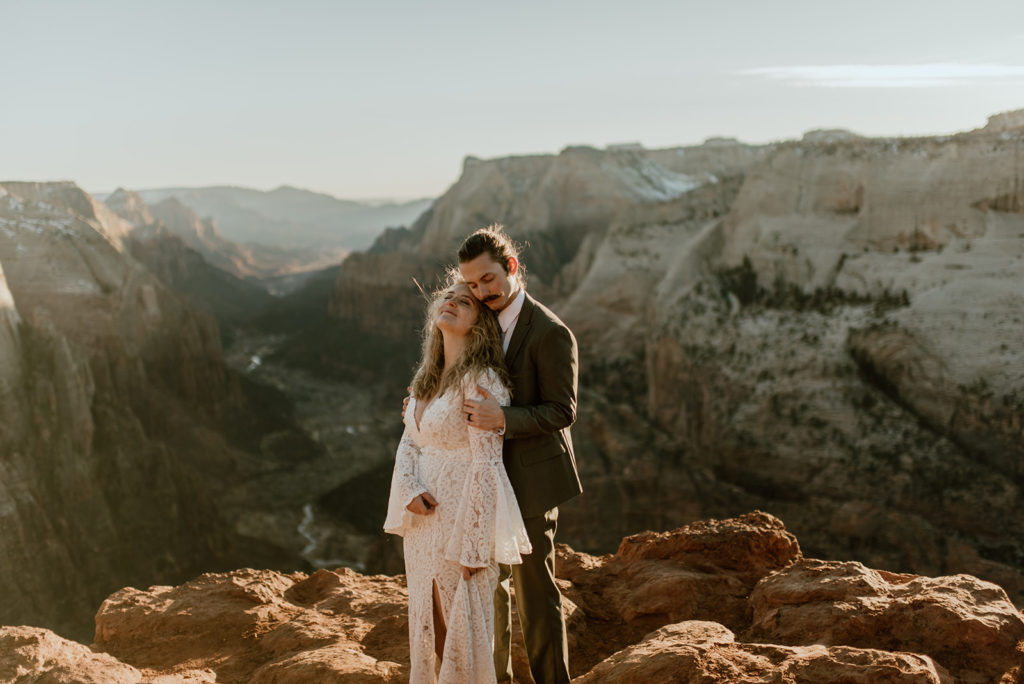Couple embraces at Zion overlook adventure elopement