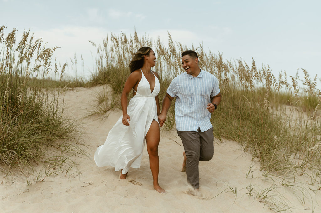 Couple runs holding hands at Virginia Beach elopement