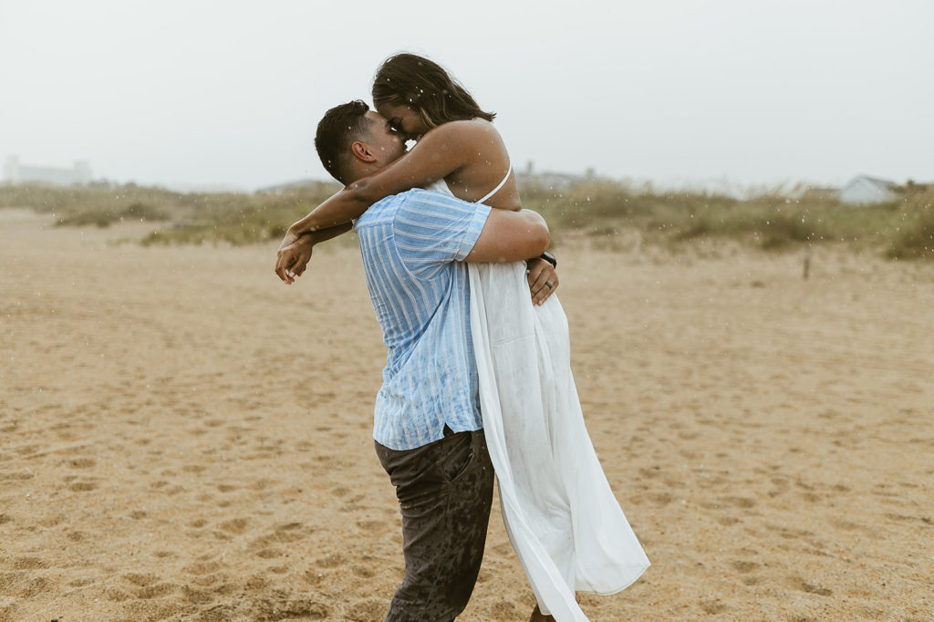 Couple embraces at rainy Virginia Beach elopement