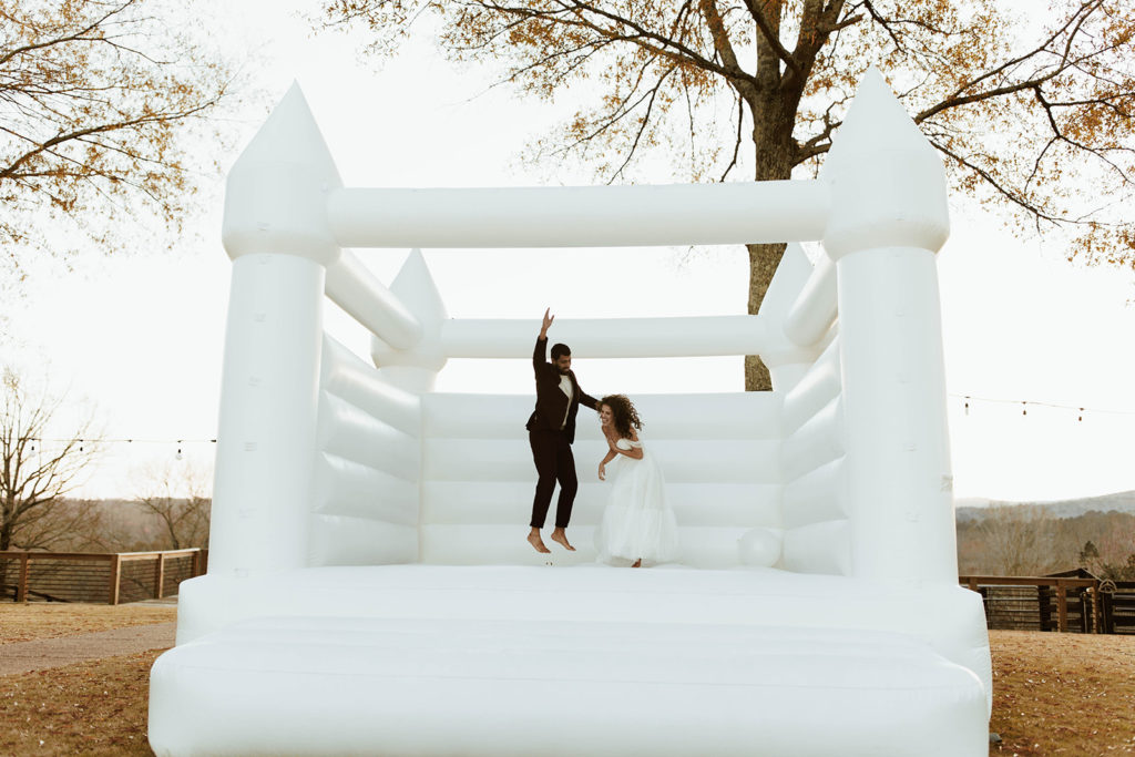 Couple jumps in bounce house at Atlanta photography content day