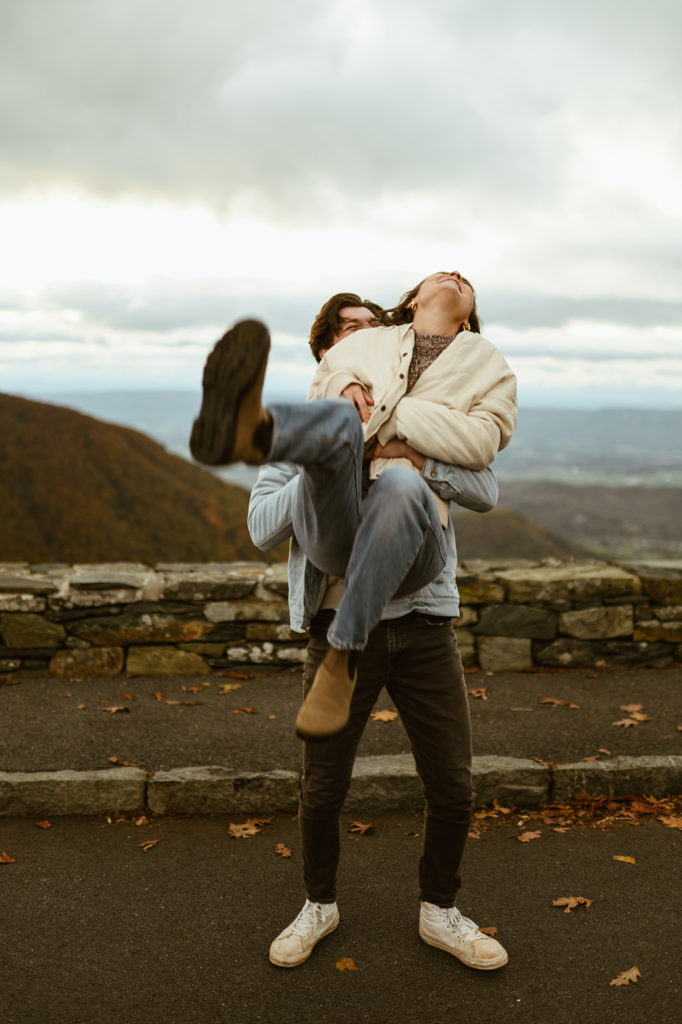 Couple embraces laughing at fall engagement session 