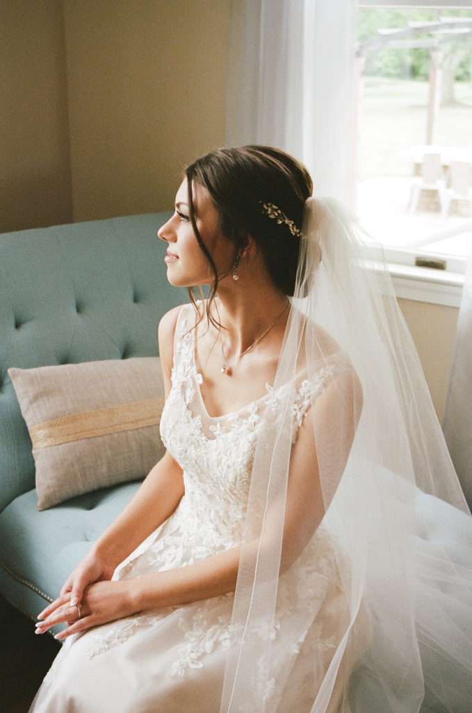 Bride seated waiting for wedding day in dress and veil