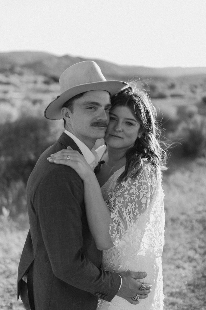Couple embraces in desert captured by traveling photographer