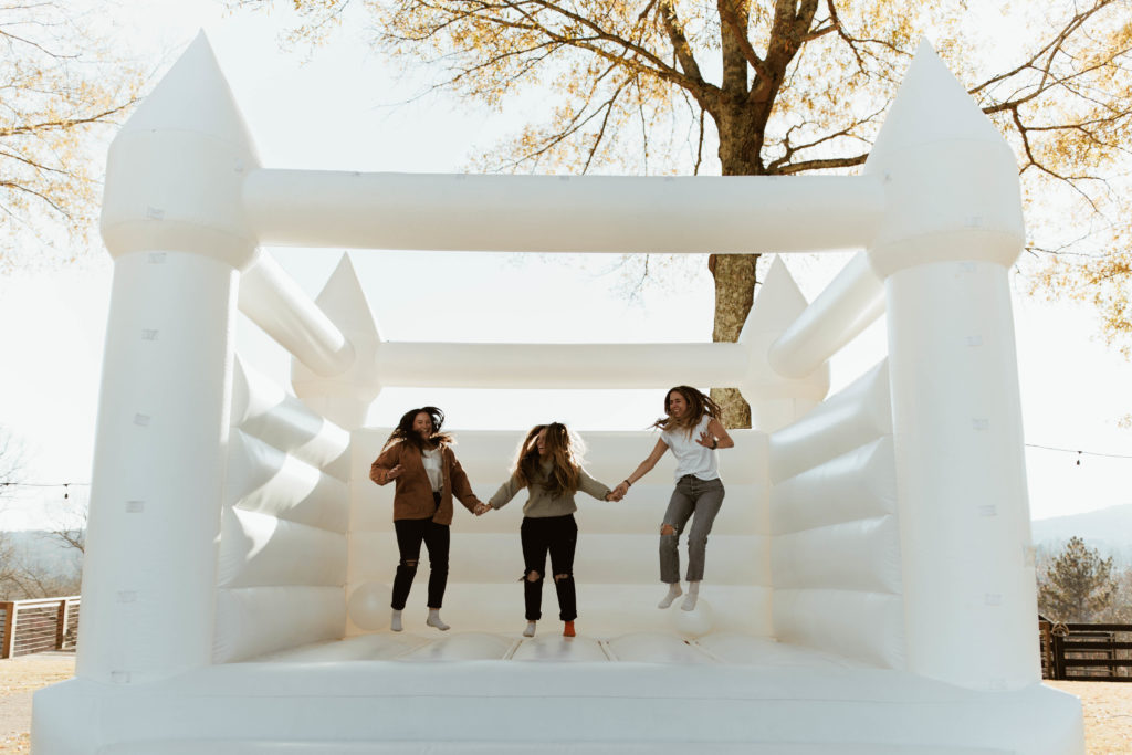 Photographers jump in bounce house at photography content day