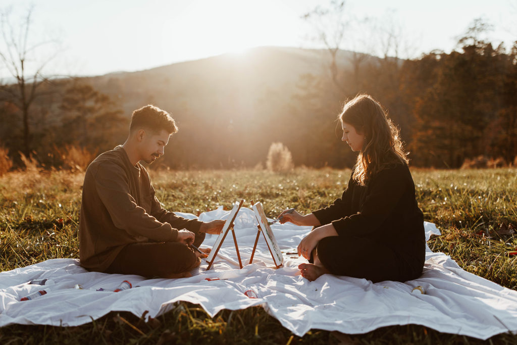 Couple paints together at outdoor sunset couples session