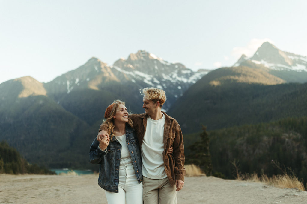 Couple embraces at mountain sunset engagement session