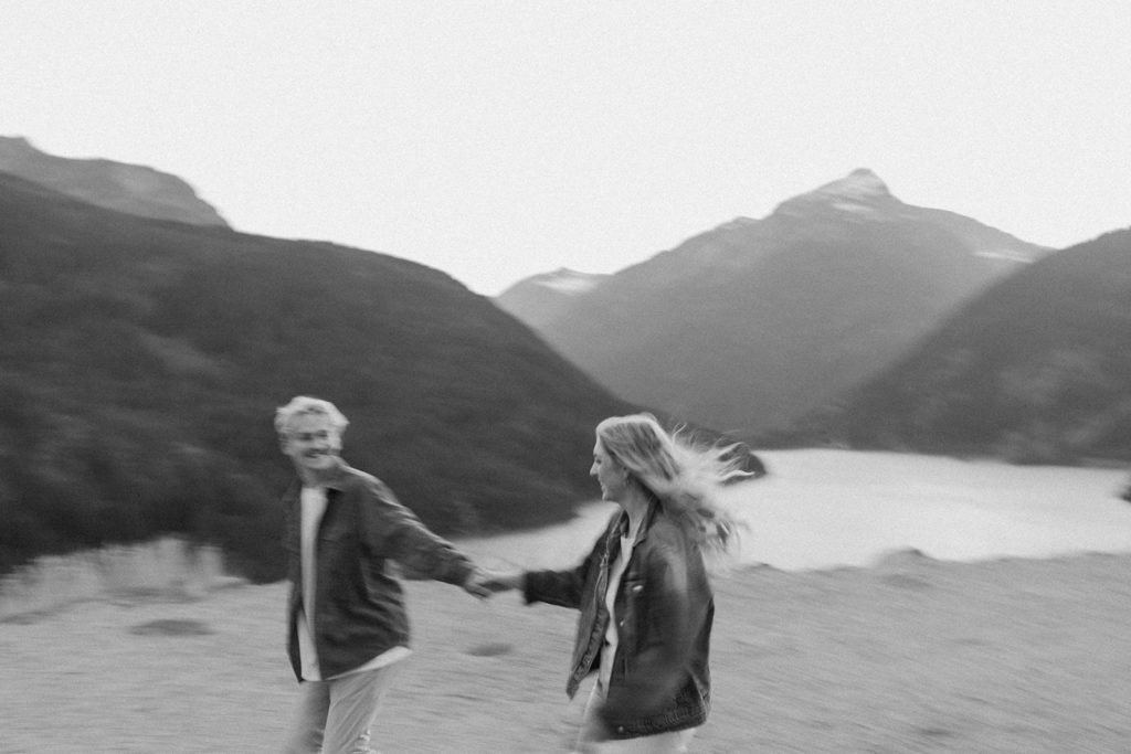couple holds hands at mountain engagement session