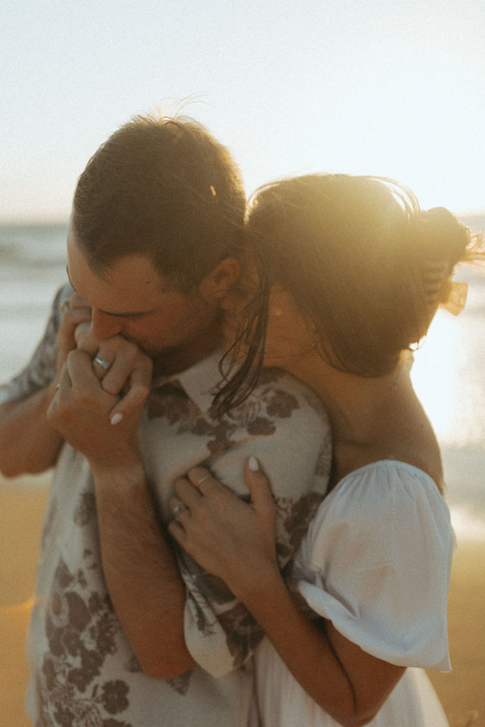 couple embraces at sunrise engagement session captured by travel photographer