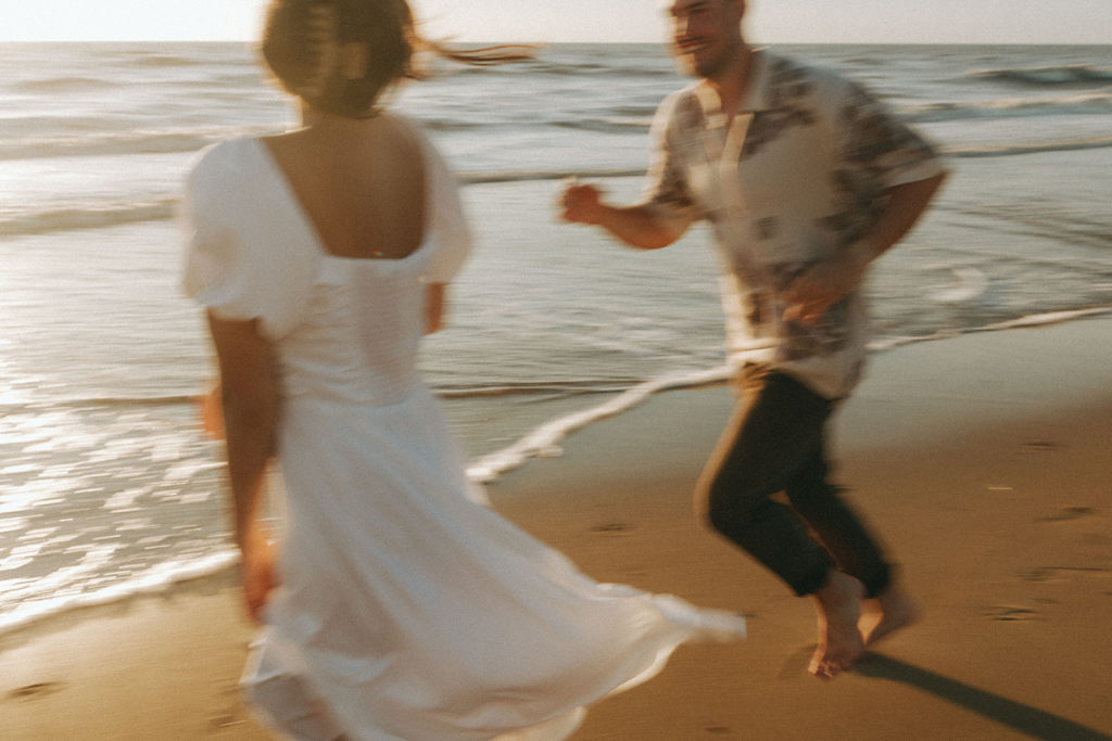 couple runs at Virginia Beach sunrise engagement session