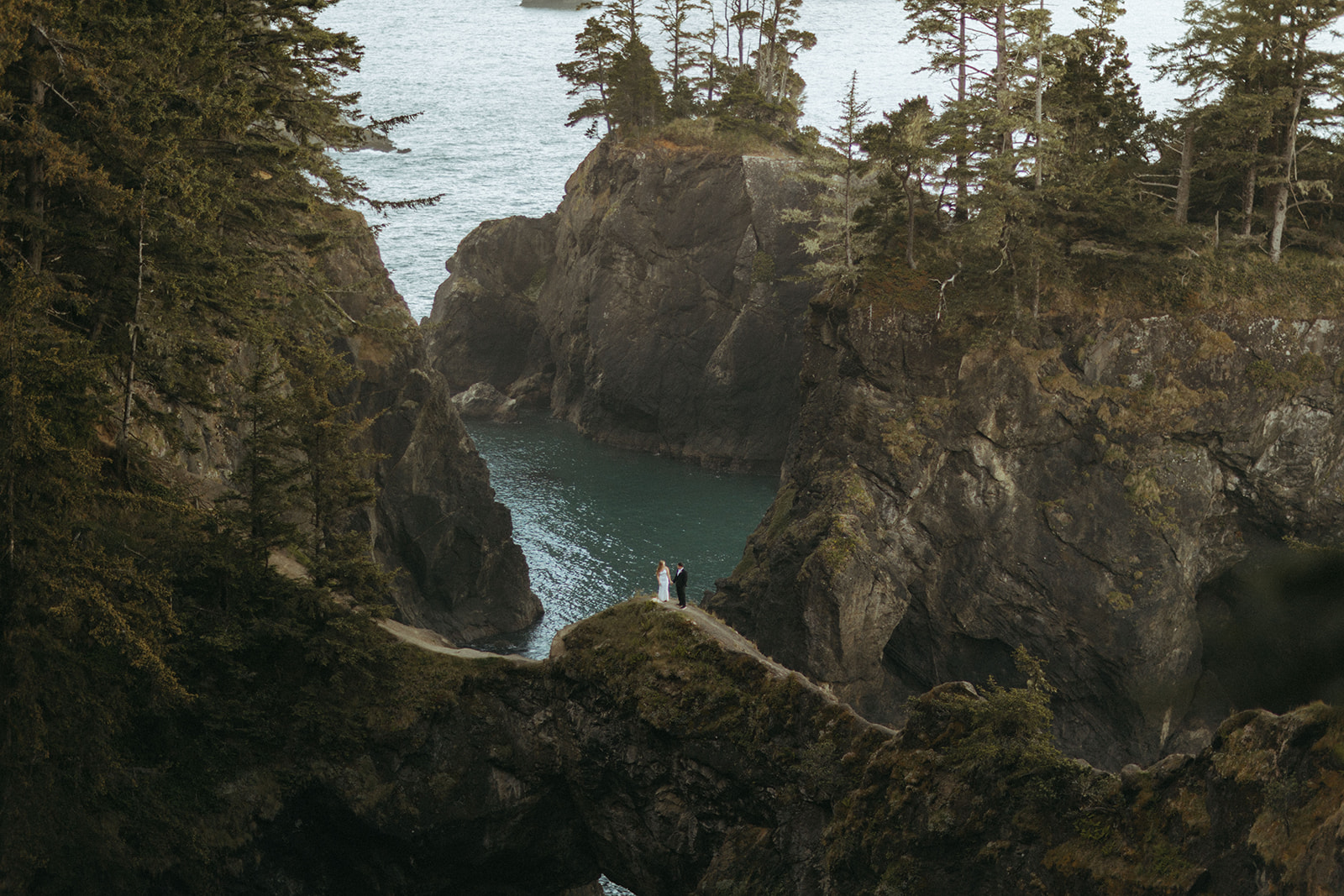 couple stands together from afar at Oregon Coast elopement