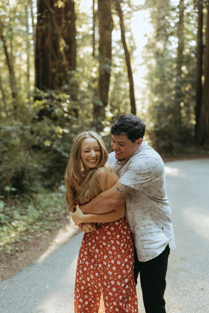 couple embraces at redwoods state park engagement session