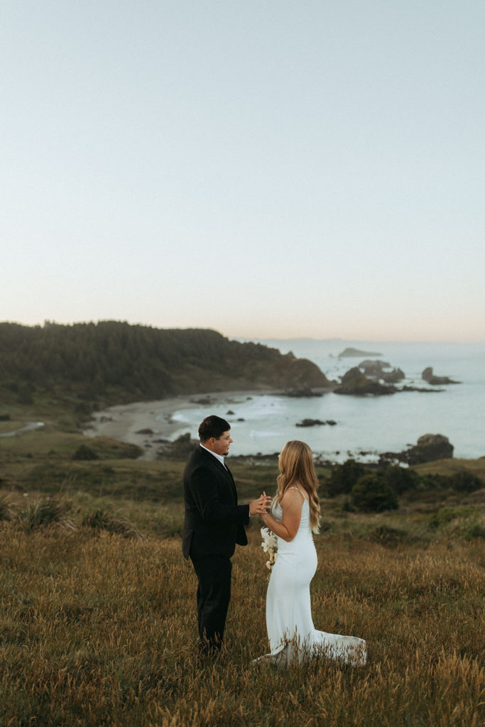 couple stands on overlook at Oregon coast wedding photoshoot