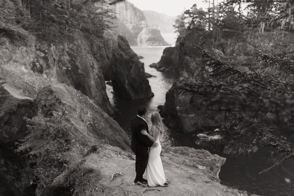 couple embraces at Oregon Coast overlook elopement wedding photoshoot