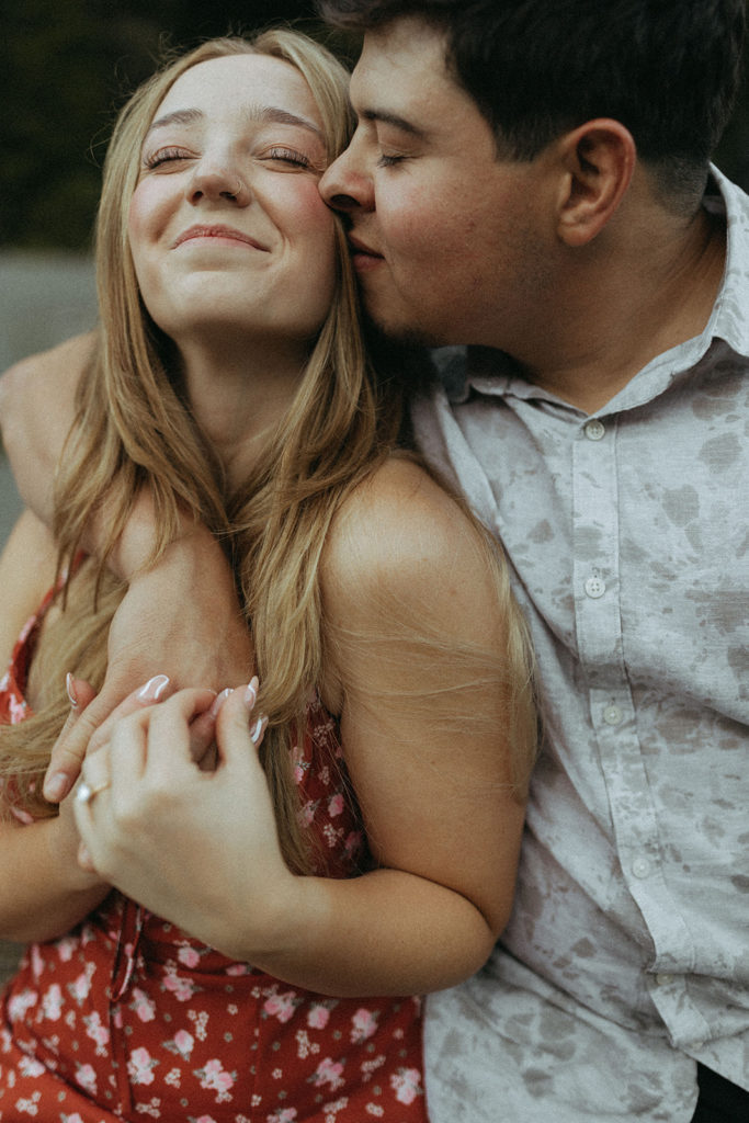 couple embraces at redwoods state park engagement session