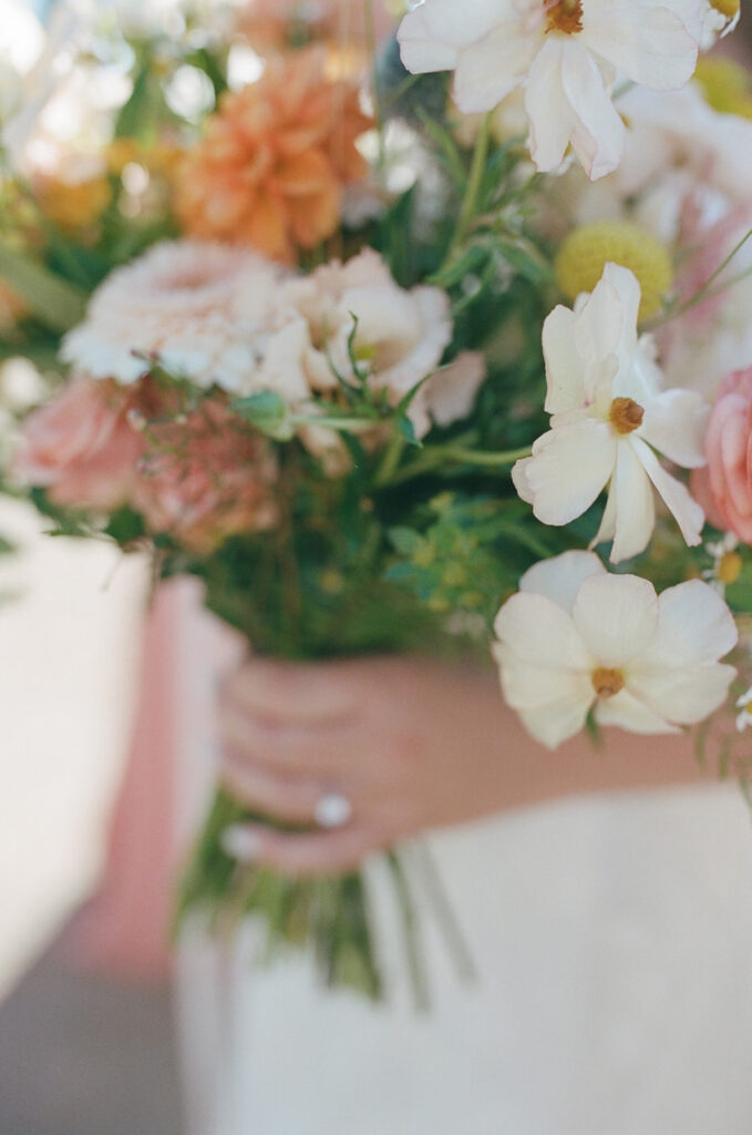 bride holds wedding bouquet as part of wedding film photography project
