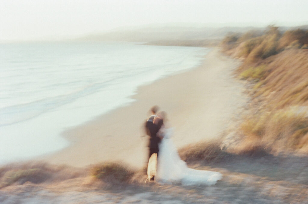blurry photo of couple standing on overlook as part of wedding film photography project
