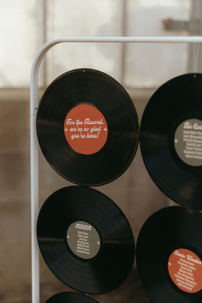 wall of vinyl records at California greenhouse wedding