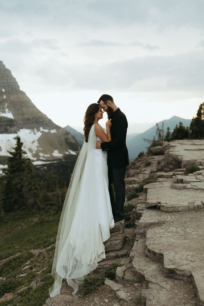 couple embraces on mountainside during outdoor elopement