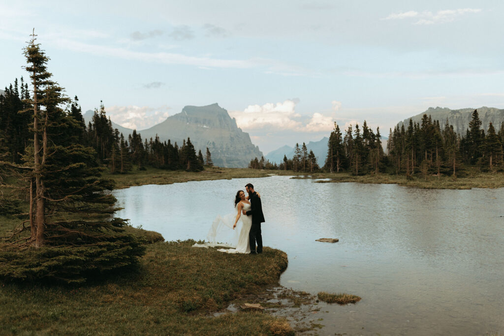 couple embraces beside lake at mountain outdoor adventure elopement