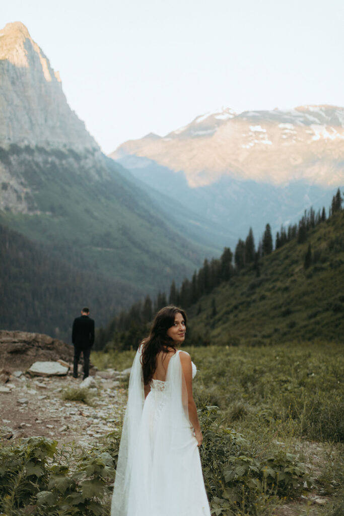 bride looks back during Glacier National Park elopement first look