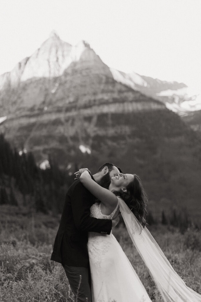 couple laughs embracing at Glacier National Park wedding
