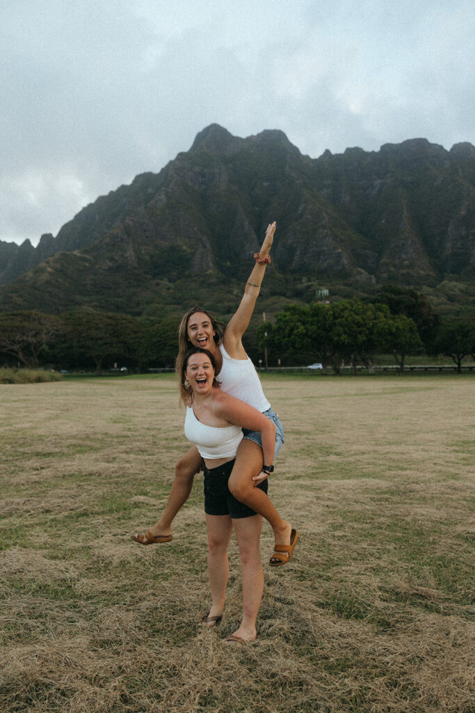 photographers laugh while carrying each other at Hawaii content day