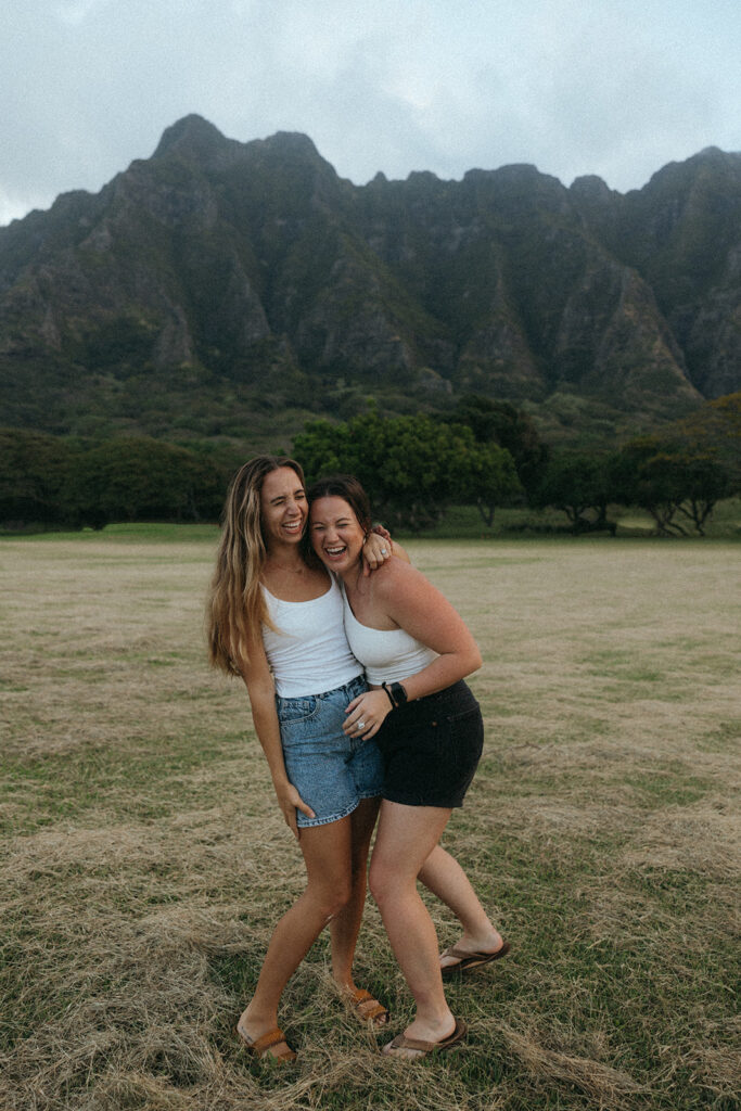 photographers laugh while hugging at Hawaii content day