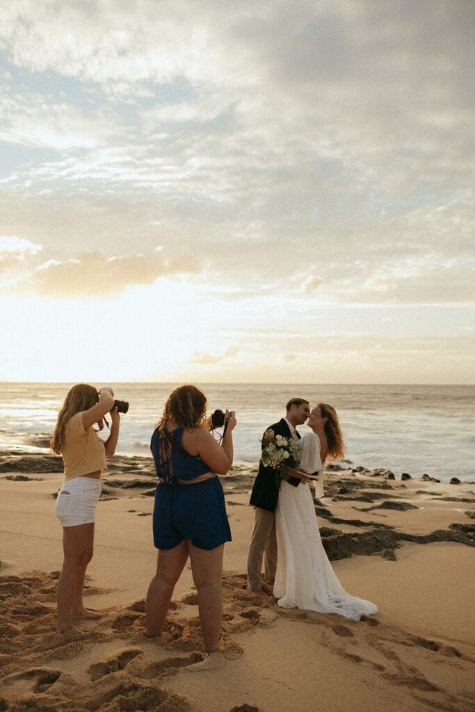 photographers photograph couple on beach at Hawaii photography content day
