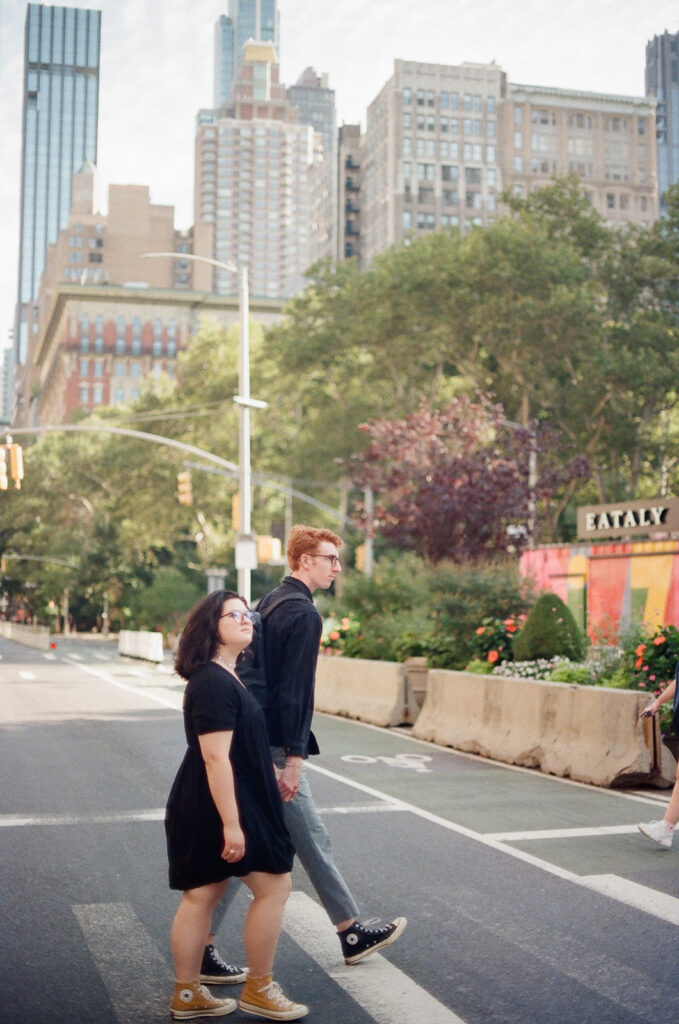 couple walks crosses new york city streets 