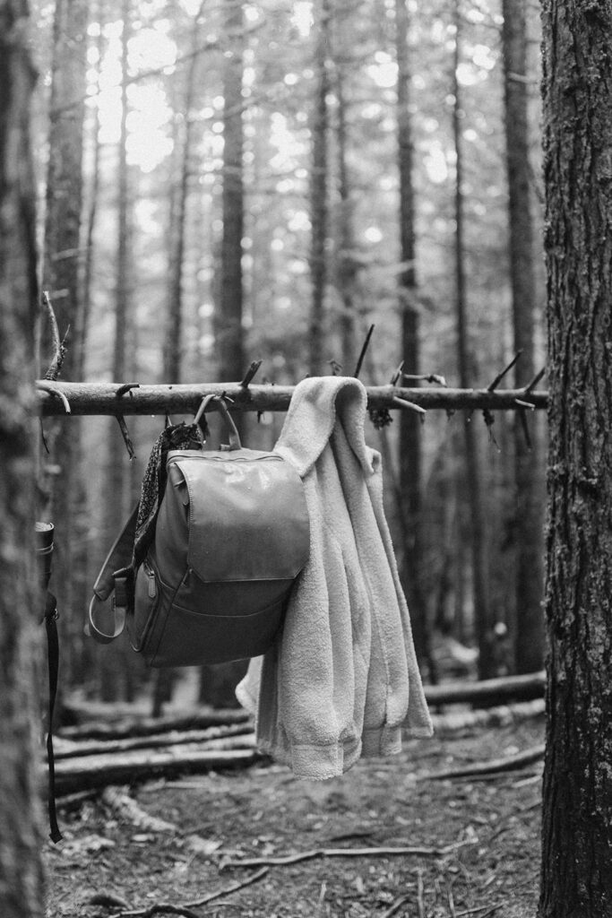 backpack and jacket hanging on tree in Glacier National Park