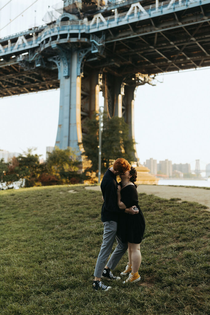 couple kisses under bridge using marriage proposal ideas