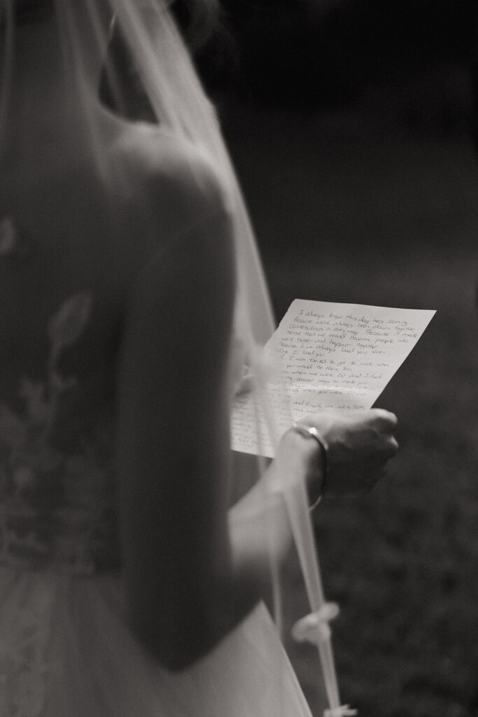 bride reads vows at garden wedding