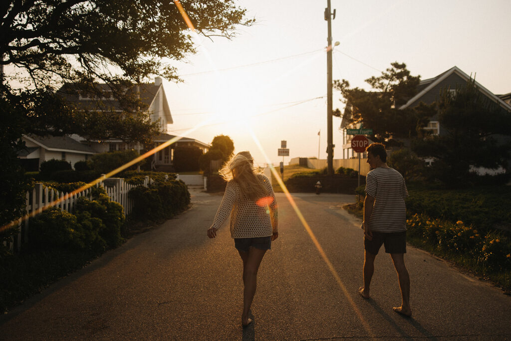 couple walks along street at Virginia Beach engagement session
