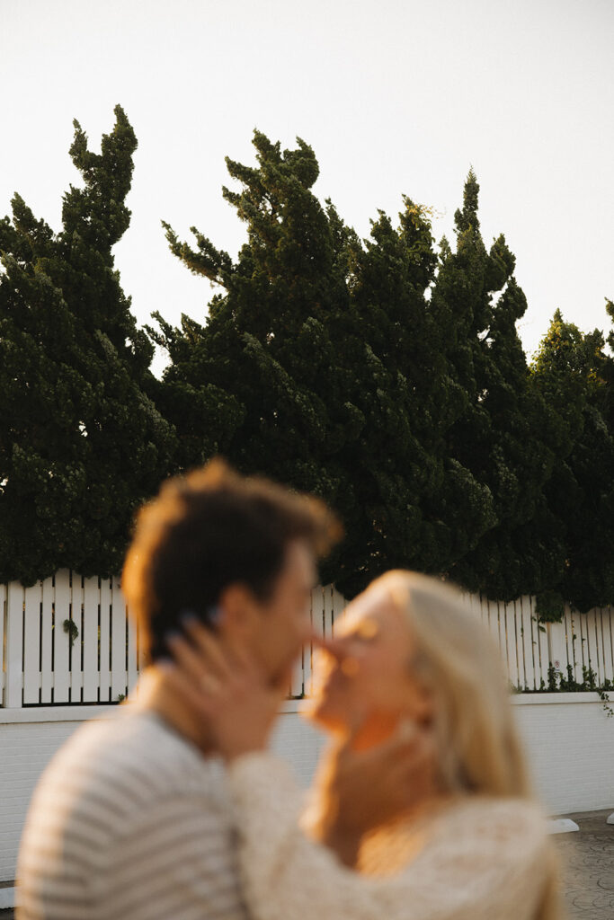 couple kisses at Virginia Beach engagement photos

