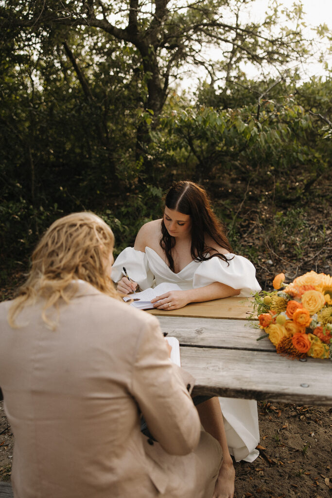couple writes wedding vows at Virginia Beach elopement