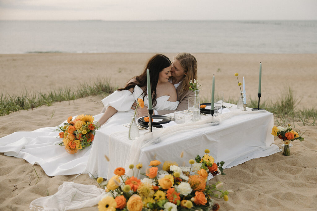 couple sits at table at Virginia Beach elopement