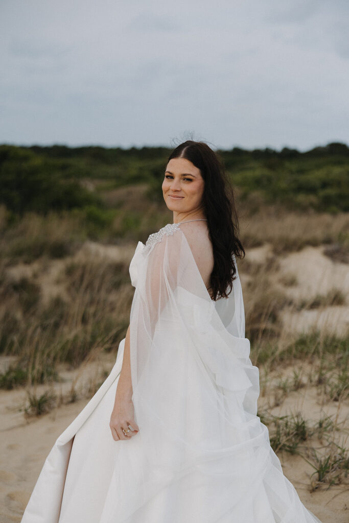 bride poses with long white wedding veil for online business coaching styled shoot