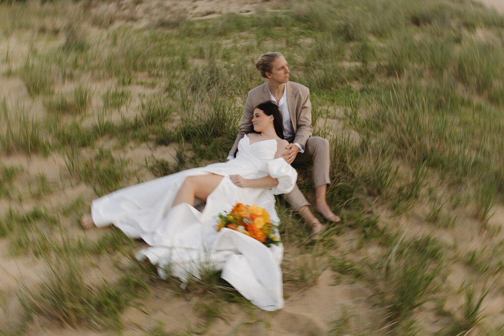 couple sits in grass for online business coaching styled shoot
