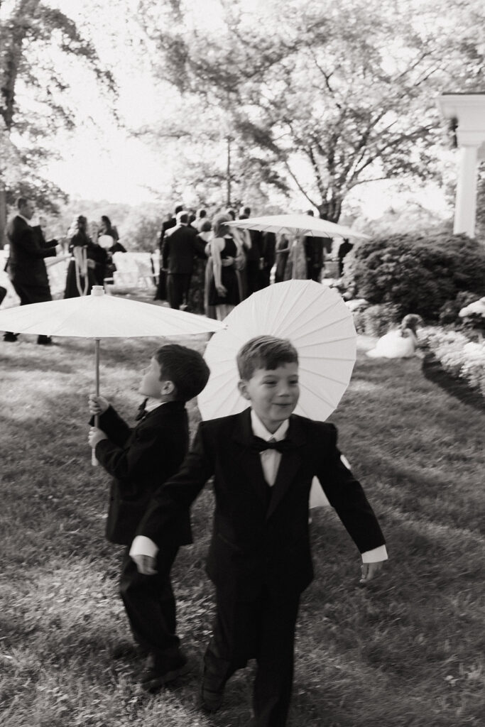 kids play with umbrellas outdoor wedding with tent