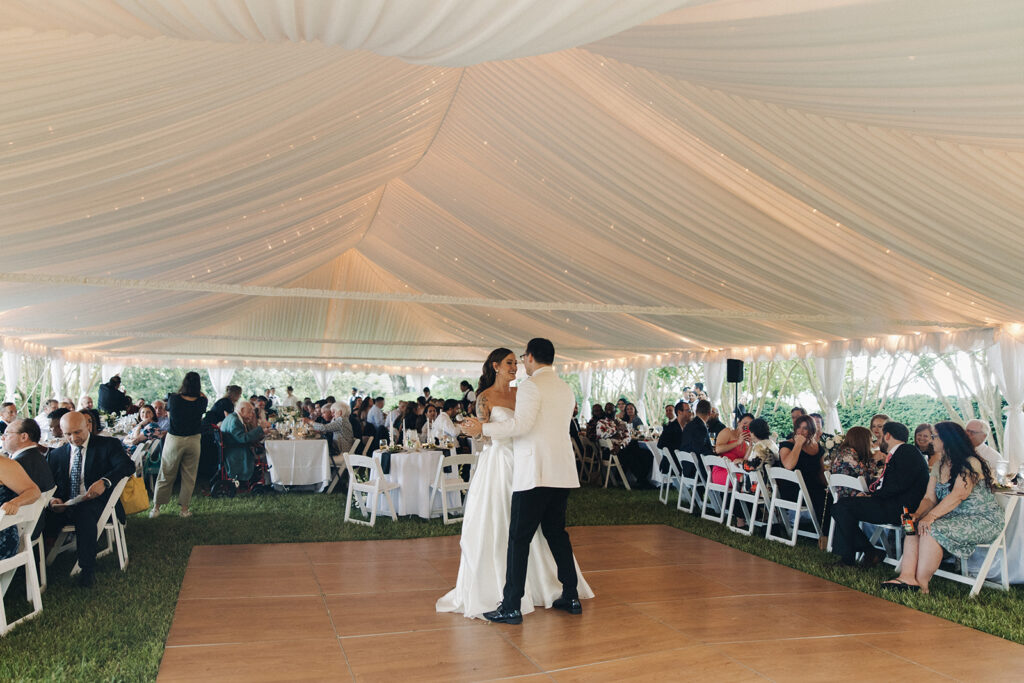 couple dances at outdoor wedding with tent