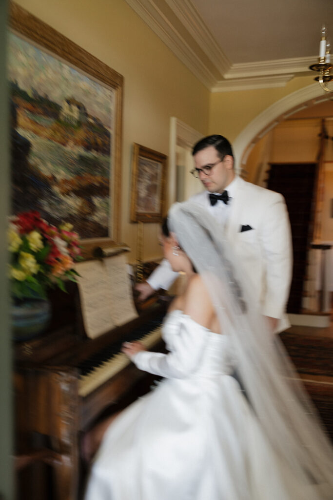 bride plays piano during wedding first look