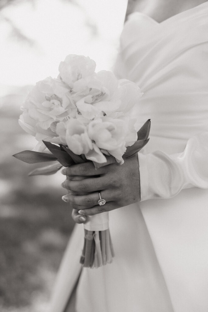 bride holds white flower wedding bouquet