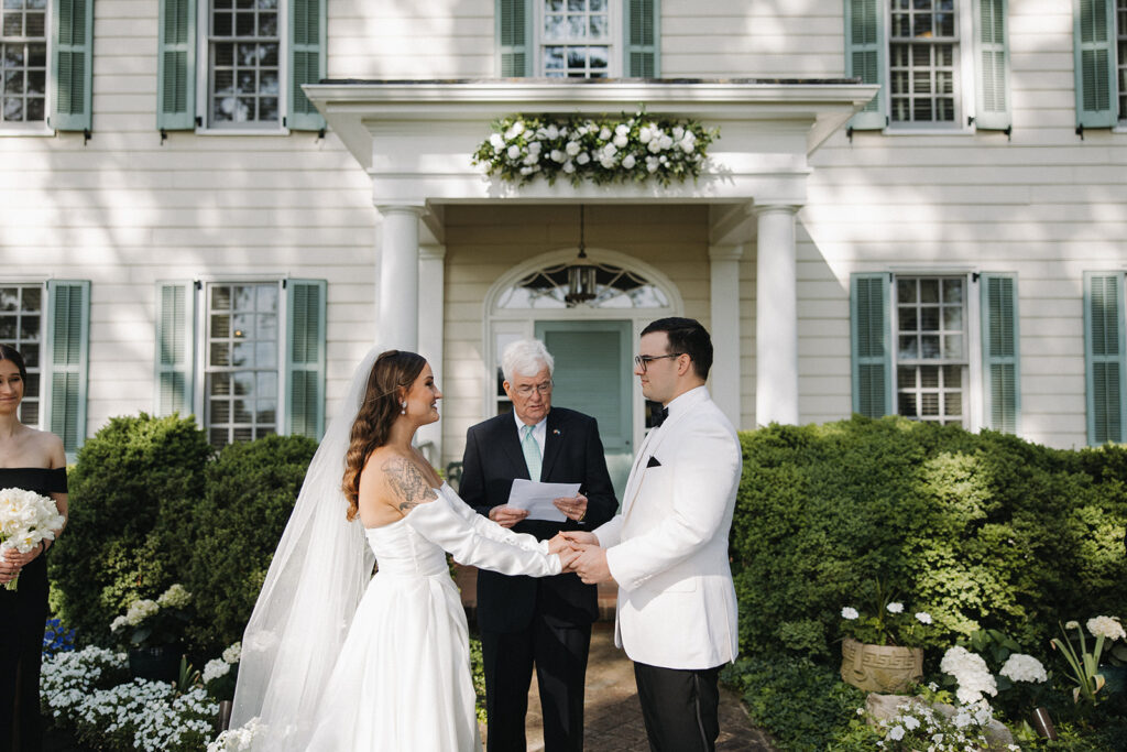 couple exchanges wedding vows at backyard wedding