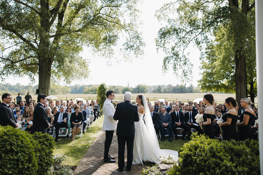 couple exchanges wedding vows at backyard wedding