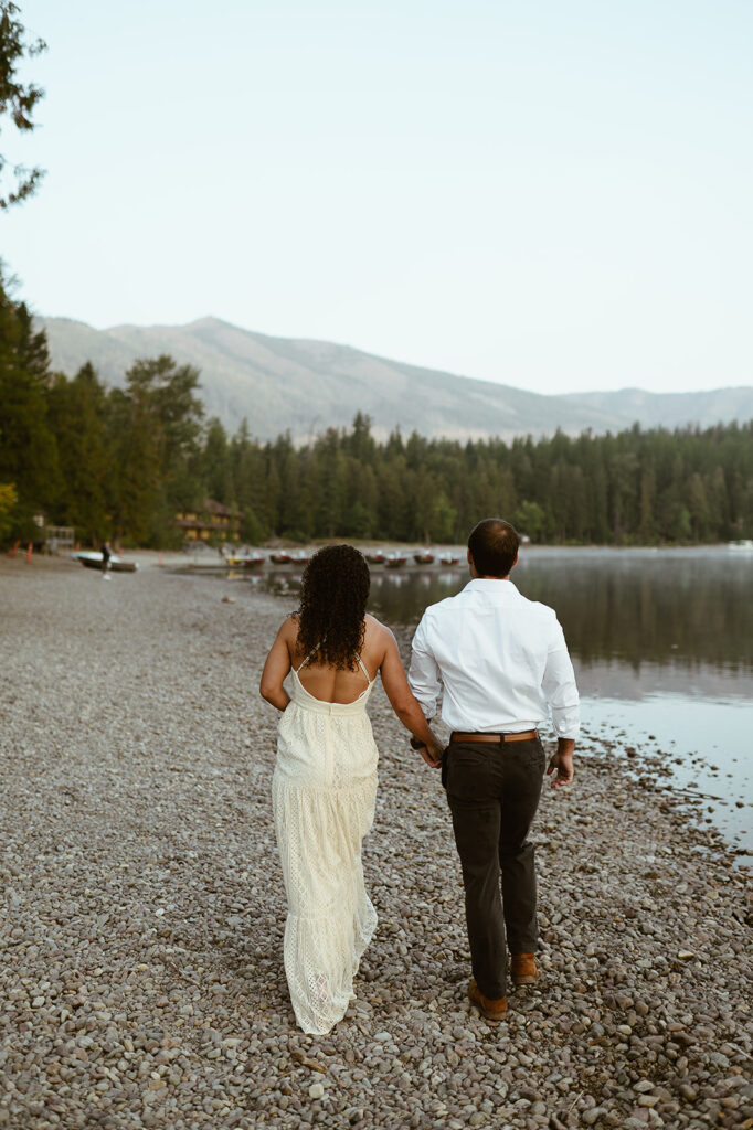 couple walks along Lake McDonald