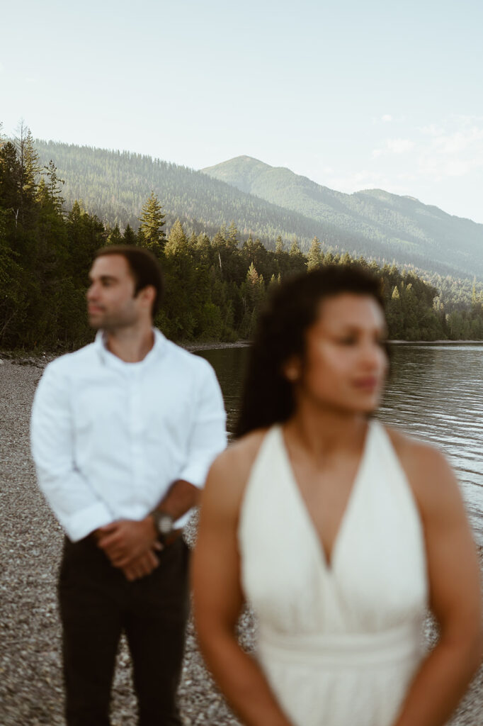couple stands together at Lake McDonald Glacier National Park