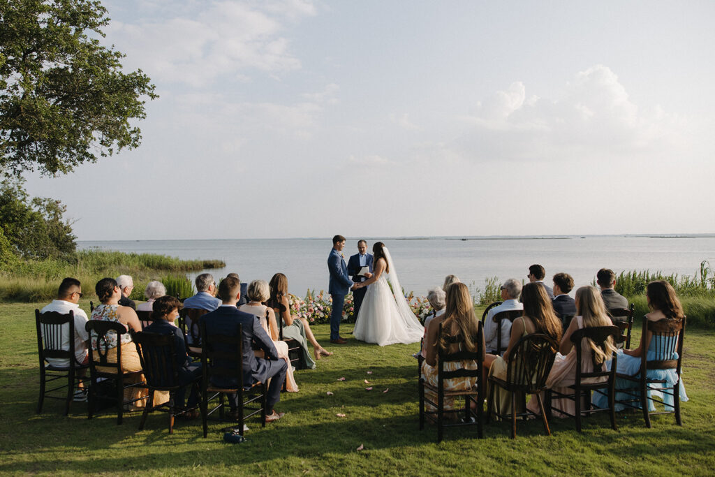 couple exchanges vows at waterfront Outer Banks wedding ceremony